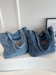 Minimalist denim tote bags in light and dark blue washes with shoulder straps