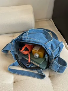 Large denim tote bag for women featuring a spacious interior and a secure zipper closure