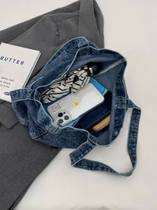 Chic blue washed denim tote bag showing spacious interior with personal essentials