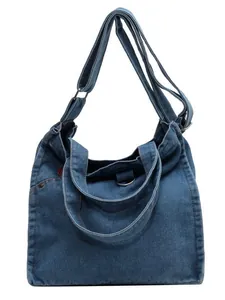 Classic blue denim tote bag with brown label, featuring top handles and shoulder strap