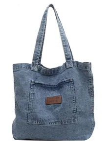 Classic blue denim tote bag with brown leather label and stylish minimalist design