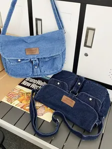 Retro denim crossbody bag with dual front pockets and adjustable shoulder strap