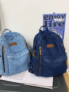 Retro denim backpack in light and dark blue with leather tag for student travel