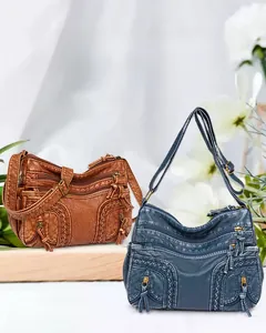 Detail view of woven vintage washed leather shoulder bags with multiple functional zipper pockets