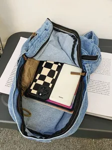 Large capacity blue denim backpack for women showing interior storage for tablets and books