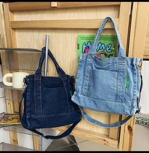 Close-up of washed denim tote bags in dark and light blue with crossbody straps