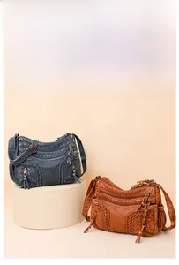 Detail showing multi-pocket washed faux leather crossbody bags in blue and brown color