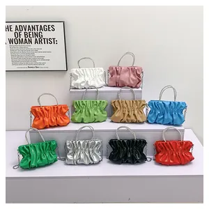 Detailed display of fashionable pleated cloud bags in ten vibrant colors on a white shelf