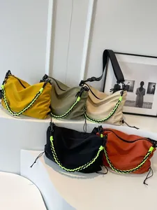 Minimalist nylon tote bags in five vibrant colors displayed on geometric studio stands