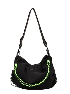 Minimalist black tote bag with neon green woven rope detail and adjustable strap