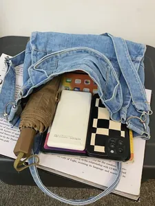 Blue washed denim shoulder bag with large capacity for daily commute essentials