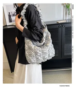 Close-up of the pleated metallic silver cloud tote bag with ruffled shoulder strap details