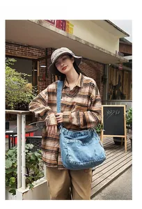 Blue denim crossbody bag shown on model featuring a large capacity vintage washed texture