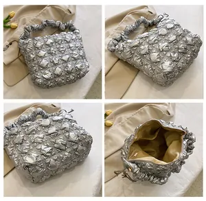 Detail showing metallic silver puff tote with inner pockets and zip closure system