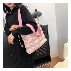 Detail of pink quilted bubble tote bag with wide straps and diamond stitched texture
