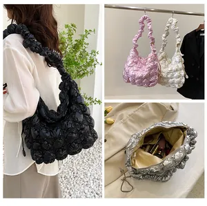 Detail view of puffer cloud tote bags in black pink white and silver with quilted texture