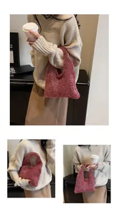 Close-up of red sequin shoulder bag paired with beige knit sweater and brown skirt
