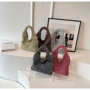 Detailed display of colorful glitter knit shoulder bags in five vibrant finishes on a podium