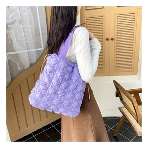 Detail of lavender quilted tote bag with bubble texture and wide shoulder strap
