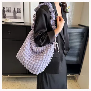 Detailed close-up of lavender bubble textured shoulder bag with soft pleated fabric detail