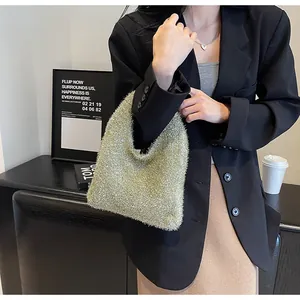 Detailed close-up of champagne gold sequin handbag with fuzzy metallic texture