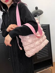 Pink quilted tote bag with diamond lattice pattern and wide shoulder strap for women