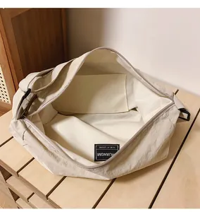 Detailed interior view of beige canvas tote bag showing inner pocket and zipper closure