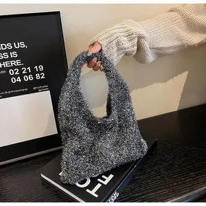 Detail of silver faux fur handbag with metallic yarn texture and soft fuzzy finish