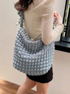 Pale blue pleated bubble cloud tote bag with large capacity shown on a model
