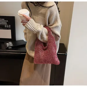 Detail of pink sequin knit tote bag shown in a lifestyle scene with soft lighting