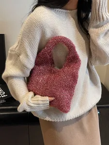 Sparkly magenta knit tote bag with metallic sequins shown from a stylish side angle