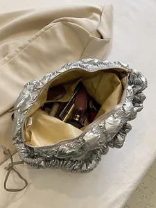 Silver metallic quilted cloud tote bag with spacious interior and ruffled shoulder strap
