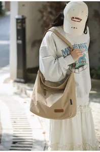 Detail of khaki canvas crossbody bag showing durable fabric and adjustable wide strap