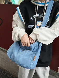 Retro denim crossbody bag in light blue canvas with front pocket for casual street style