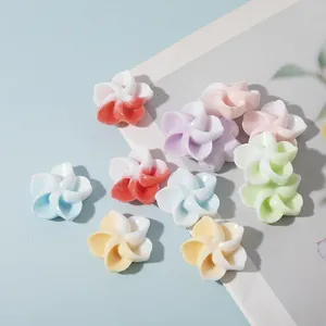 Macro detail of colorful 3D resin flower beads with white gradient for DIY jewelry making