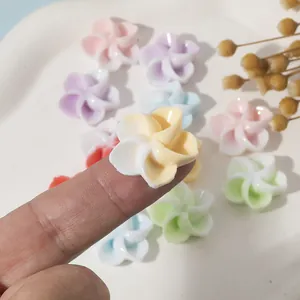 Macro shot of colorful resin flower charms for DIY jewelry making and crafts