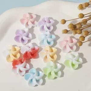 Close-up of assorted colorful resin 5-petal flower charms for DIY jewelry and hair accessories