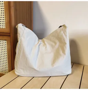 Close-up of lightweight textured nylon tote bag placed on a wooden surface