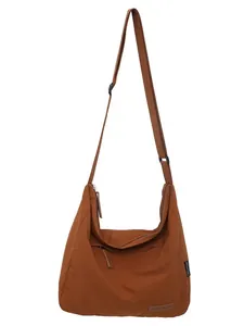 Large caramel canvas crossbody bag for women with adjustable wide strap and zipper closure