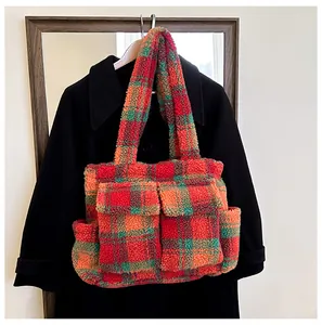 Detail of colorful plaid plush tote bag with functional flap pockets and soft lamb wool texture