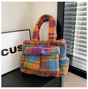 Detail of the colorful plush checkerboard tote bag featuring front flap pockets and soft texture
