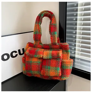 Detail view of large checkered fleece tote bag showing plush texture and front pockets
