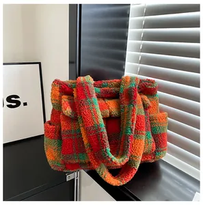 Detail of checkered sherpa tote bag with soft texture and spacious side pockets