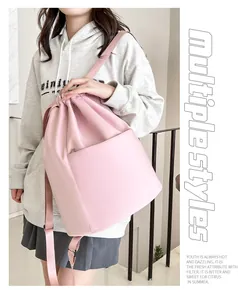 Close-up of pink nylon drawstring backpack with large pocket on a street model