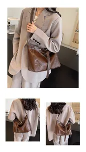 Detail view of large dark brown hobo tote bag in soft vintage leather with metal rivets