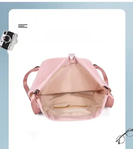 Detail view of pink nylon backpack interior featuring a zippered pocket and large capacity