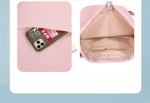 Detail view of pink nylon backpack featuring front zipper pocket and internal storage pouch
