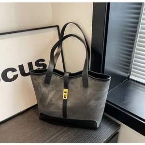 Detailansicht der dunkelgrauen Shopper-Tasche mit Steinstruktur und Gold-Drehverschluss