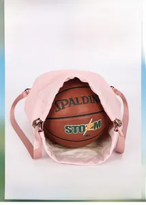 Pink nylon drawstring backpack detail showing large capacity with an inner basketball