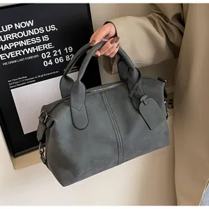 Detail der dunkelgrau-grünen Boston Bag mit Doppelgriffen und matter Wildledertextur